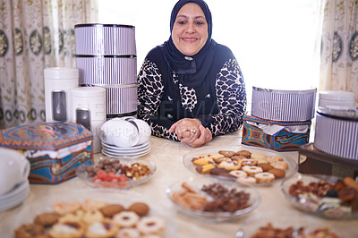 Buy stock photo Woman, Muslim and cakes in house for celebration, cheerful and dining table with food for Iftar in Ramadan. Islamic person, dessert and joy in Eid Mubarak, religion and holiday or event at home