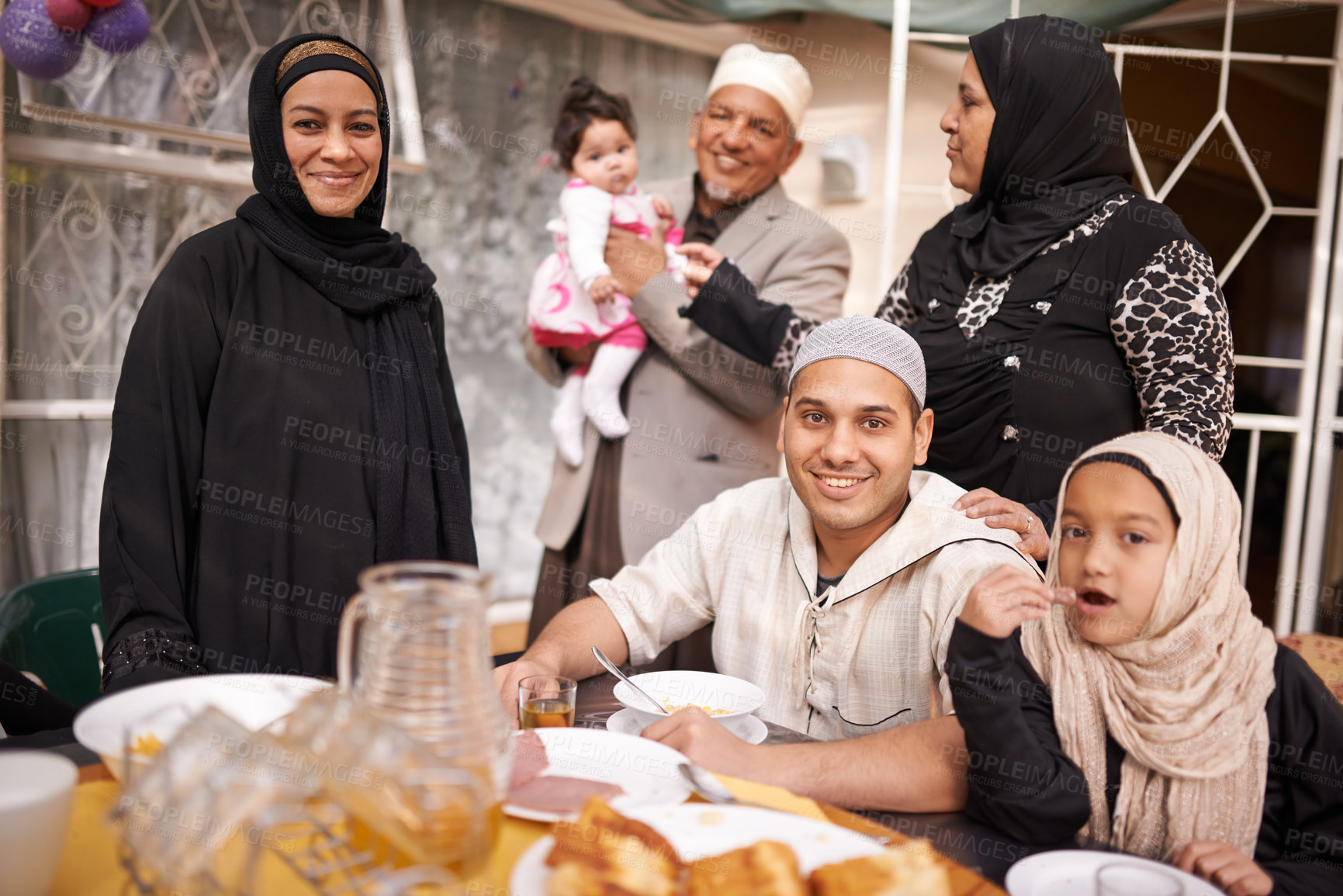 Buy stock photo Shot of a muslim family eating together