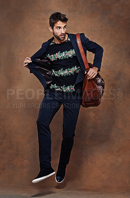 Buy stock photo Fashion, jump and pose for male person, studio and business clothing isolated on background. Confidence, stylish and bag for employee or worker man model, professional and formal and trendy outfit