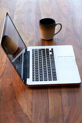 Buy stock photo Remote work with a coffee and laptop on a desk for blogging or social media browsing at a modern restaurant. Computer, freelance and research with wireless technology on a wooden surface from above