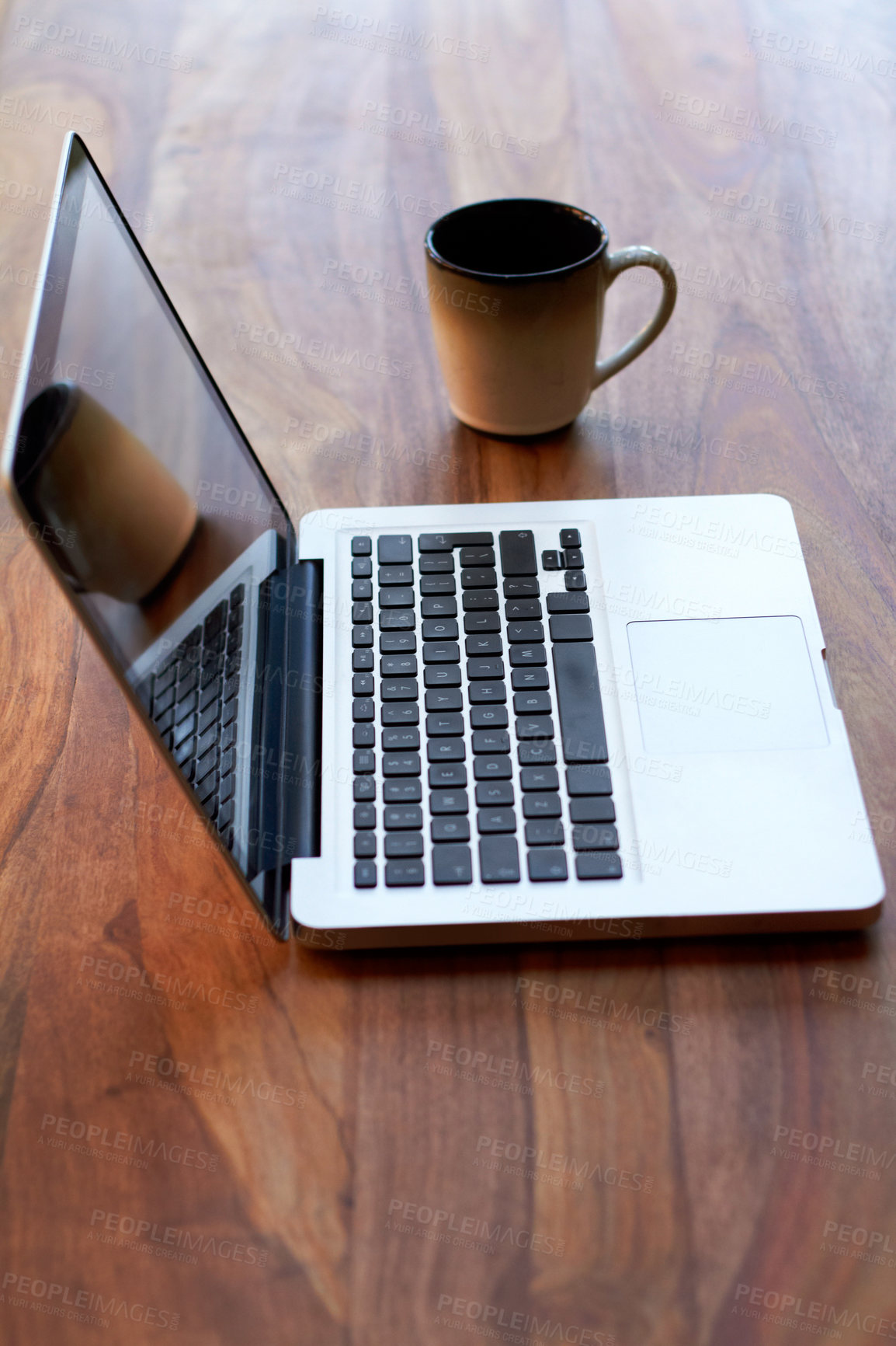 Buy stock photo Remote work with a coffee and laptop on a desk for blogging or social media browsing at a modern restaurant. Computer, freelance and research with wireless technology on a wooden surface from above