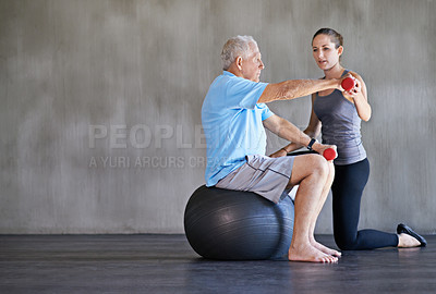 Buy stock photo Physiotherapist, dumbbells and senior man on ball for fitness, rehabilitation or exercise at gym on mockup space. Elderly person, weightlifting or training for physical therapy, help or body health