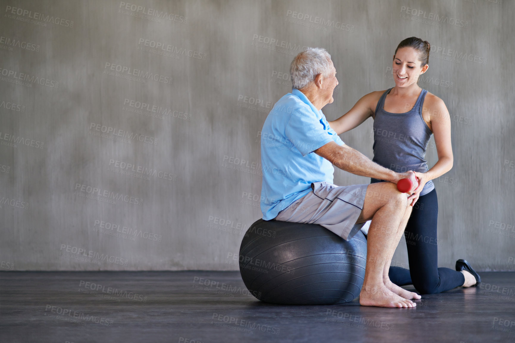 Buy stock photo Physiotherapist, dumbbells and happy elderly man on ball for fitness or rehabilitation at gym on mockup. Senior person, weightlifting and personal trainer help for body health or physical therapy