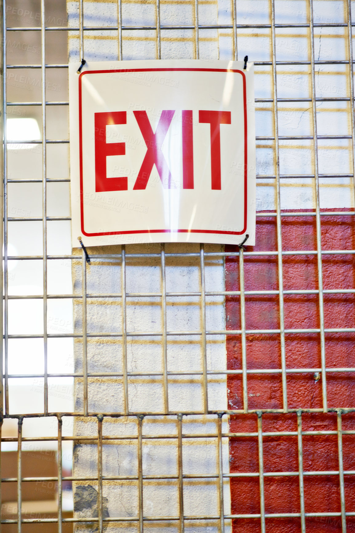 Buy stock photo Exit, safety or warehouse with a sign on factory cage in a small business for storage or workplace. Industrial background, words and gate with info, notice or poster for emergency warning or escape