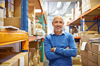 Buy stock photo Portrait of a warehouse employee standing beside shelving filled with boxes