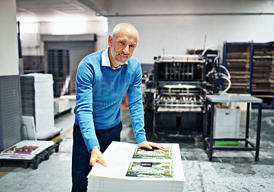 Buy stock photo Portrait of a man checking the quality of a print run in a factory