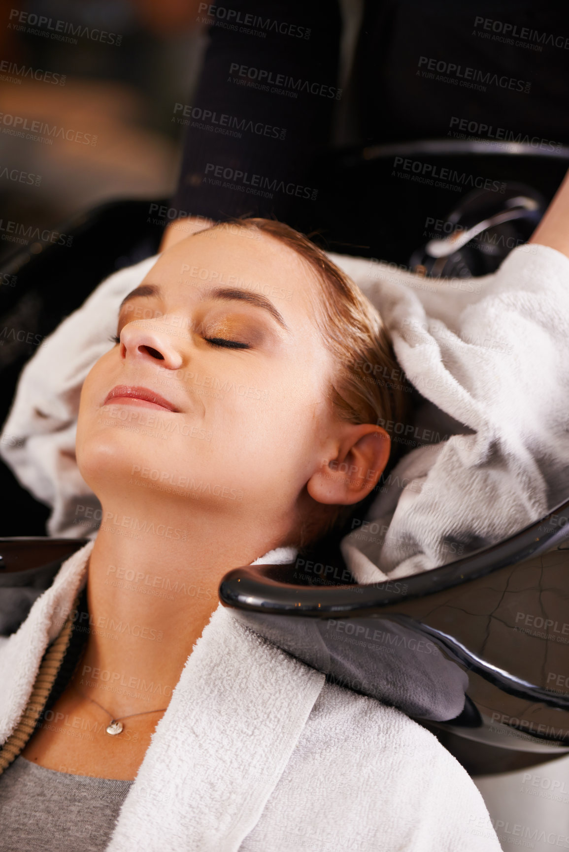 Buy stock photo Towel, washing and woman at sink with hairdresser for professional haircare, cleaning or luxury treatment. Grooming, hair care and client at salon basin with soap, water and small business service