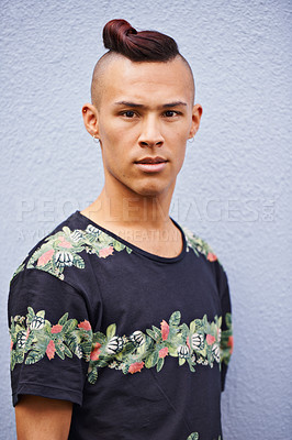 Buy stock photo Serious, confidence and portrait of man with fashion for cool style, trendy clothes and relax by wall. Male person, face and t-shirt with pride for summer, outfit and earrings on white background