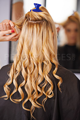 Buy stock photo A blonde woman getting her hair styled in a salon