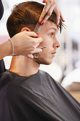 Buy stock photo Cropped shot of a young man having his hair cut by a stylist