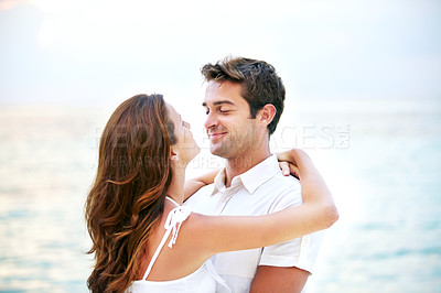 Buy stock photo Happy couple, love and hug at beach in nature, support and relax on honeymoon adventure in outdoor. Young man, woman and smile for bonding in marriage, sea and travel on summer getaway in cape town