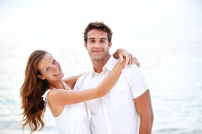 Buy stock photo Happy couple, portrait and hug by ocean in nature, support and relax on honeymoon adventure in outdoor. Young man, woman and face or bonding in marriage, sea and travel on summer holiday in cape town