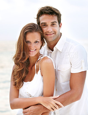Buy stock photo Happy couple, portrait and young love at beach, hug and travel on honeymoon adventure in sunshine. Man, woman and smile face for bonding in marriage, touch and together on ocean vacation in cape town