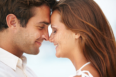 Buy stock photo  Happy couple, nose touch and love by ocean for commitment and travel on honeymoon in sunshine. Man, woman and face together for bonding in marriage, leisure and satisfaction on vacation in cape town