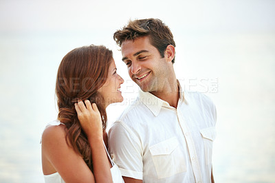 Buy stock photo  Happy couple, romantic and love by ocean on vacation and travel for honeymoon adventure in nature. Man, woman and smile face for bonding together with care, peace and trip for commitment in marriage