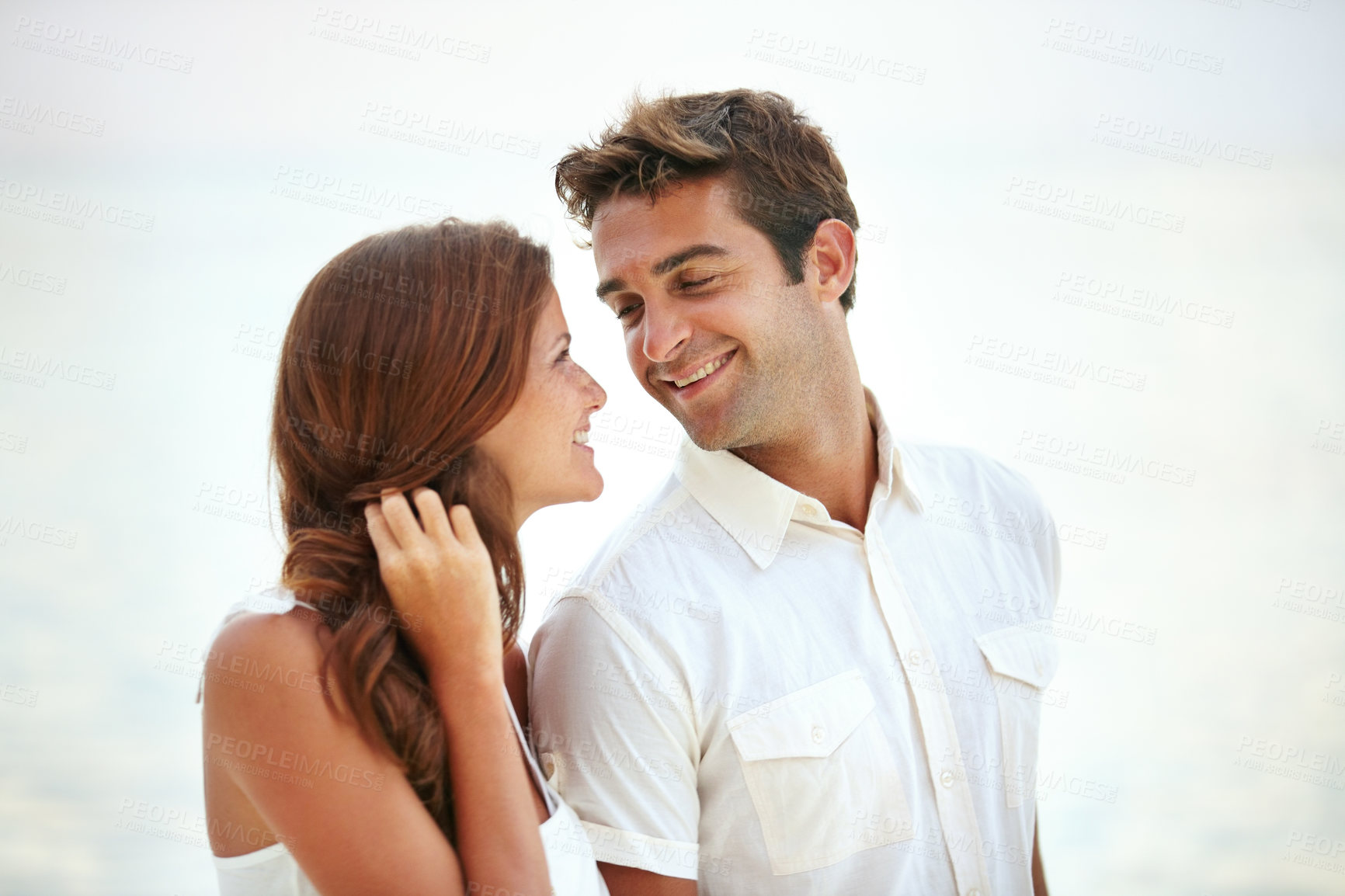 Buy stock photo  Happy couple, romantic and love by ocean on vacation and travel for honeymoon adventure in nature. Man, woman and smile face for bonding together with care, peace and trip for commitment in marriage