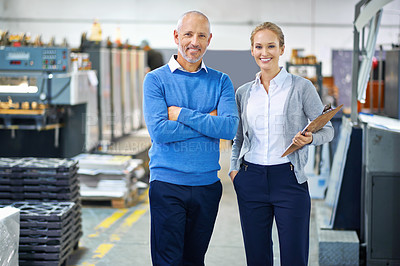 Buy stock photo Two managers on the factory floor looking confident
