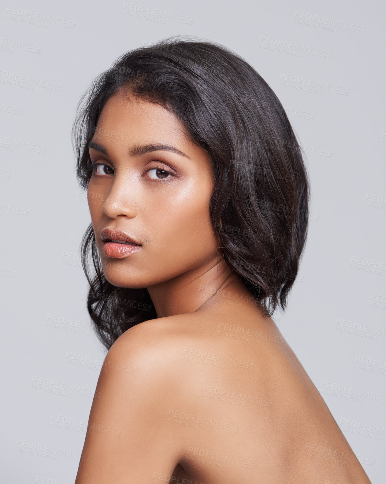 Buy stock photo Shot of a beautiful young posing over a gray background