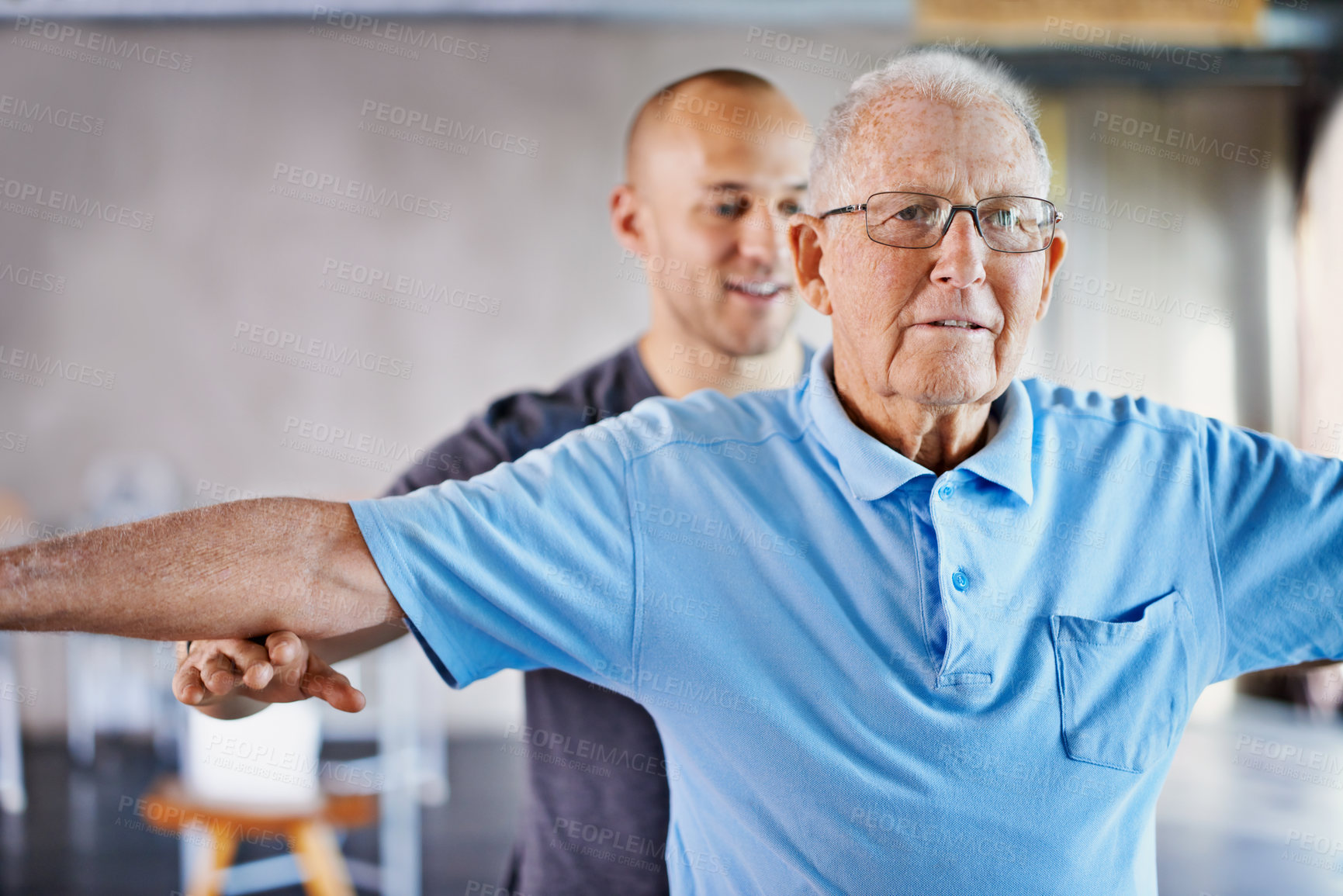 Buy stock photo A trainer helping an elderly man with fitness