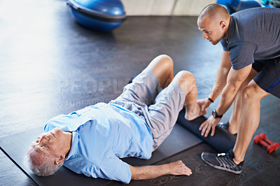 Buy stock photo Cropped shot of a handsome personal trainer with a senior man