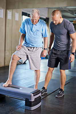 Buy stock photo Physiotherapist, helping and senior man with cardio, training and elderly support for care. Men, gym and exercise for health, wellness and coaching with aerobic step for mature rehab and wellbeing