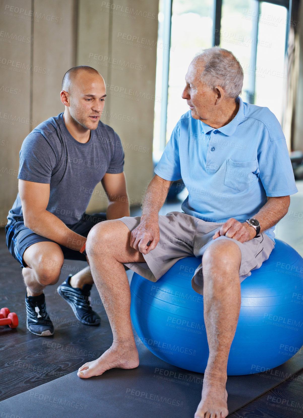 Buy stock photo Cropped shot of a handsome personal trainer with a senior man