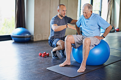 Buy stock photo Cropped shot of a handsome personal trainer with a senior man