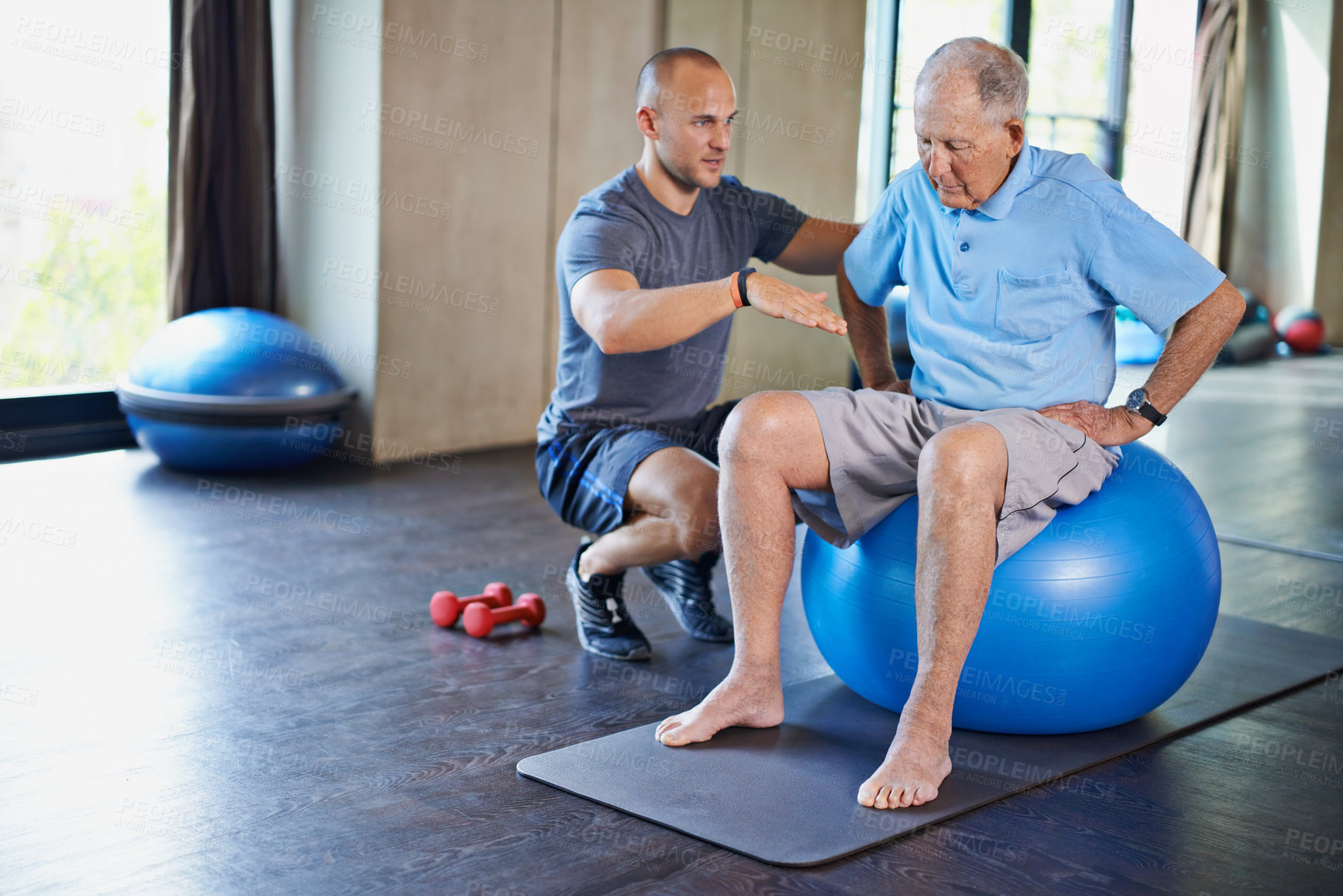 Buy stock photo Cropped shot of a handsome personal trainer with a senior man