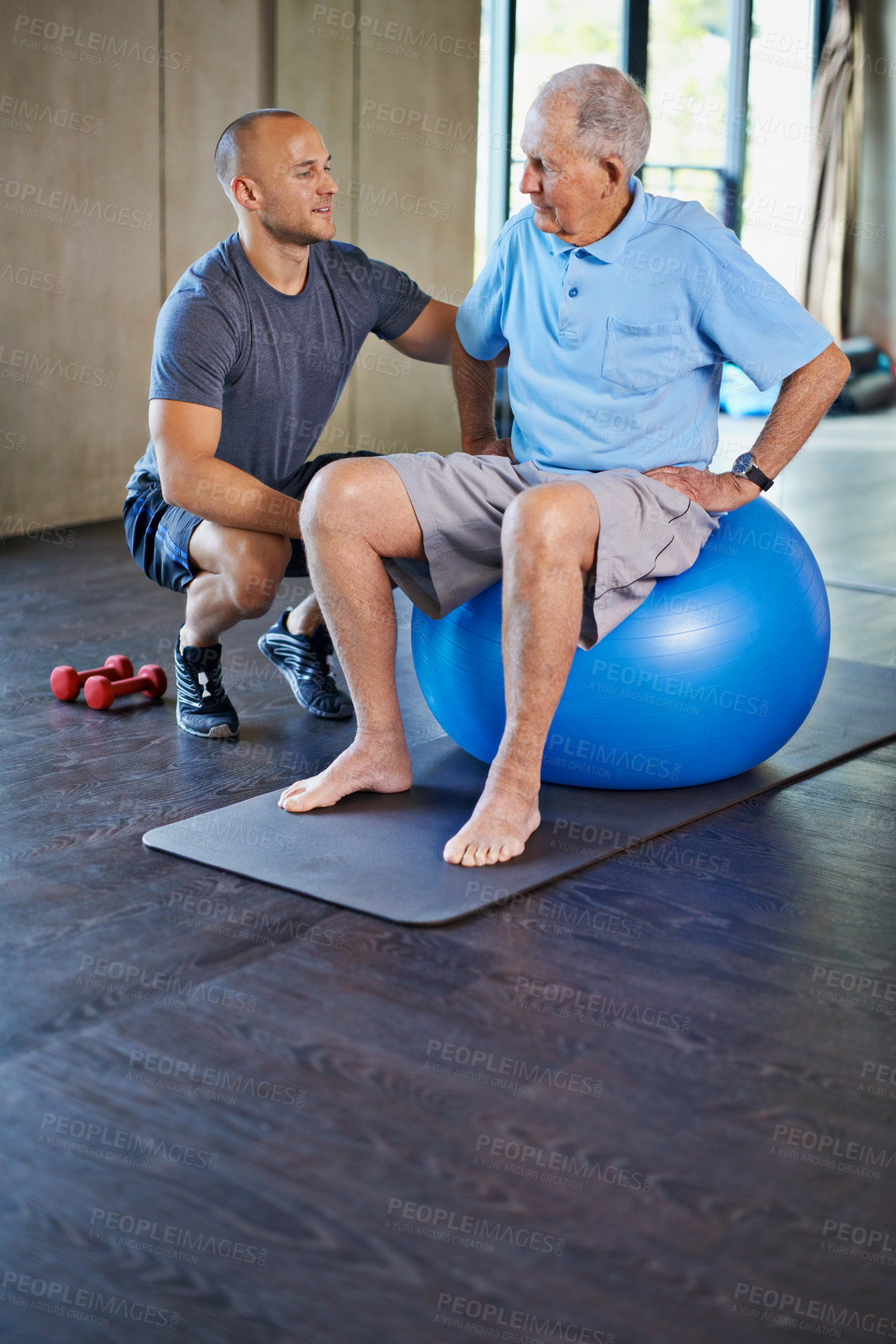 Buy stock photo Cropped shot of a handsome personal trainer with a senior man