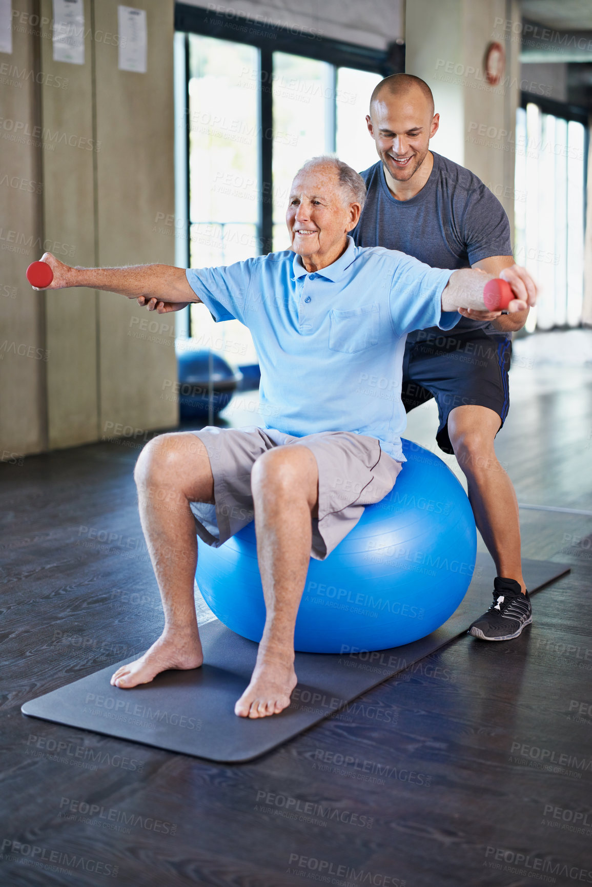 Buy stock photo Physiotherapist, helping and senior man with dumbbell, training and elderly support for care. Men, gym and exercise for health, wellness and coaching with yoga ball for mature rehab and wellbeing