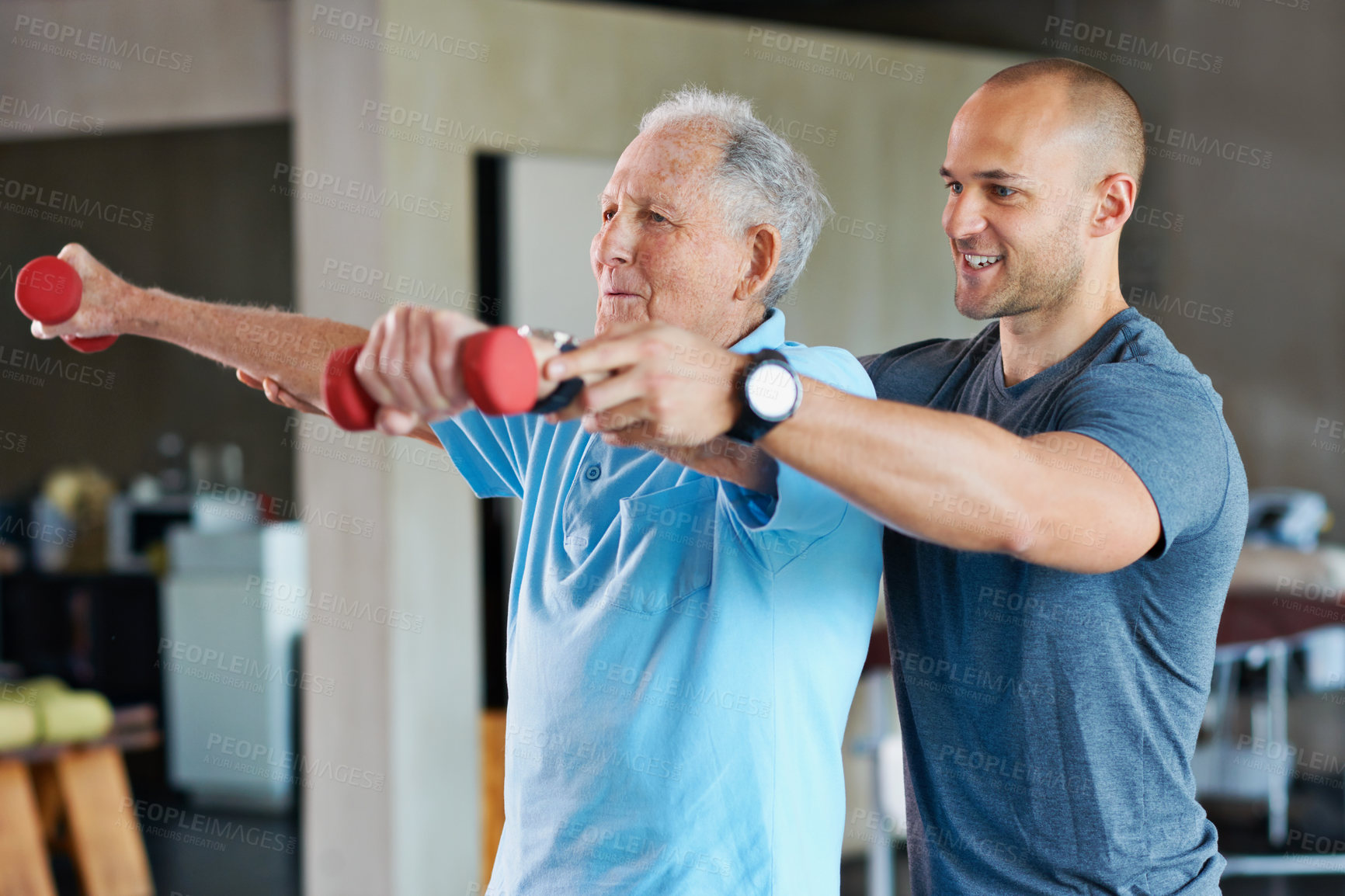 Buy stock photo Shot of a physiotherapist helping a senior man with weights