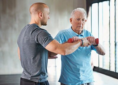 Buy stock photo Physiotherapist, senior man and weight workout for health and wellness therapy in retirement. Healthcare, physio and exercise for recovery with dumbbell for medical wellbeing and elderly male person