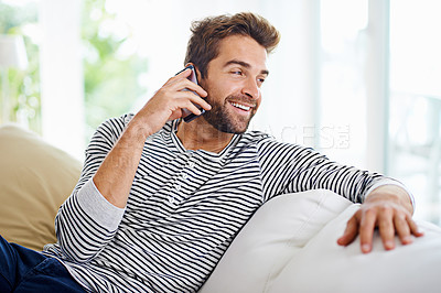 Buy stock photo Man using his cellphone at home