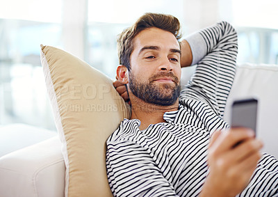 Buy stock photo Man, relax and smartphone on sofa in living room for for communication, social media and or texting. Cellphone, happy and male person for internet browsing, notification or online chat on weekend
