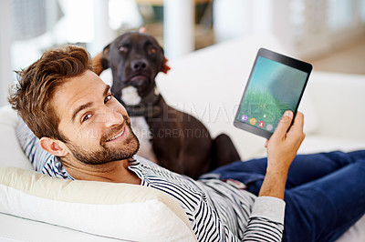 Buy stock photo Man using his tablet on his couch