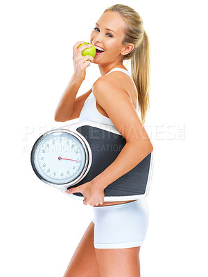 Buy stock photo Scale, apple and woman in studio for weightloss for health, wellness and diet snack. Smile, fitness and portrait of female person eating fruit for exercise, workout or training by white background.