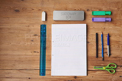 Buy stock photo Table, notebook and stationery for school project or assignment on creative art, design and drawing. Wooden desk, supplies and pen for writing exams or test with blank page for ideas and planning 