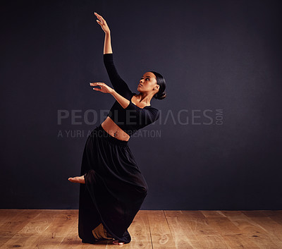 Buy stock photo Female contemporary dancer in a dramatic pose against dark background