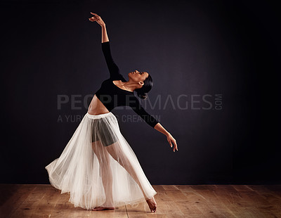 Buy stock photo Young female contemporary dancer using a soft white white skirt for dramatic effect