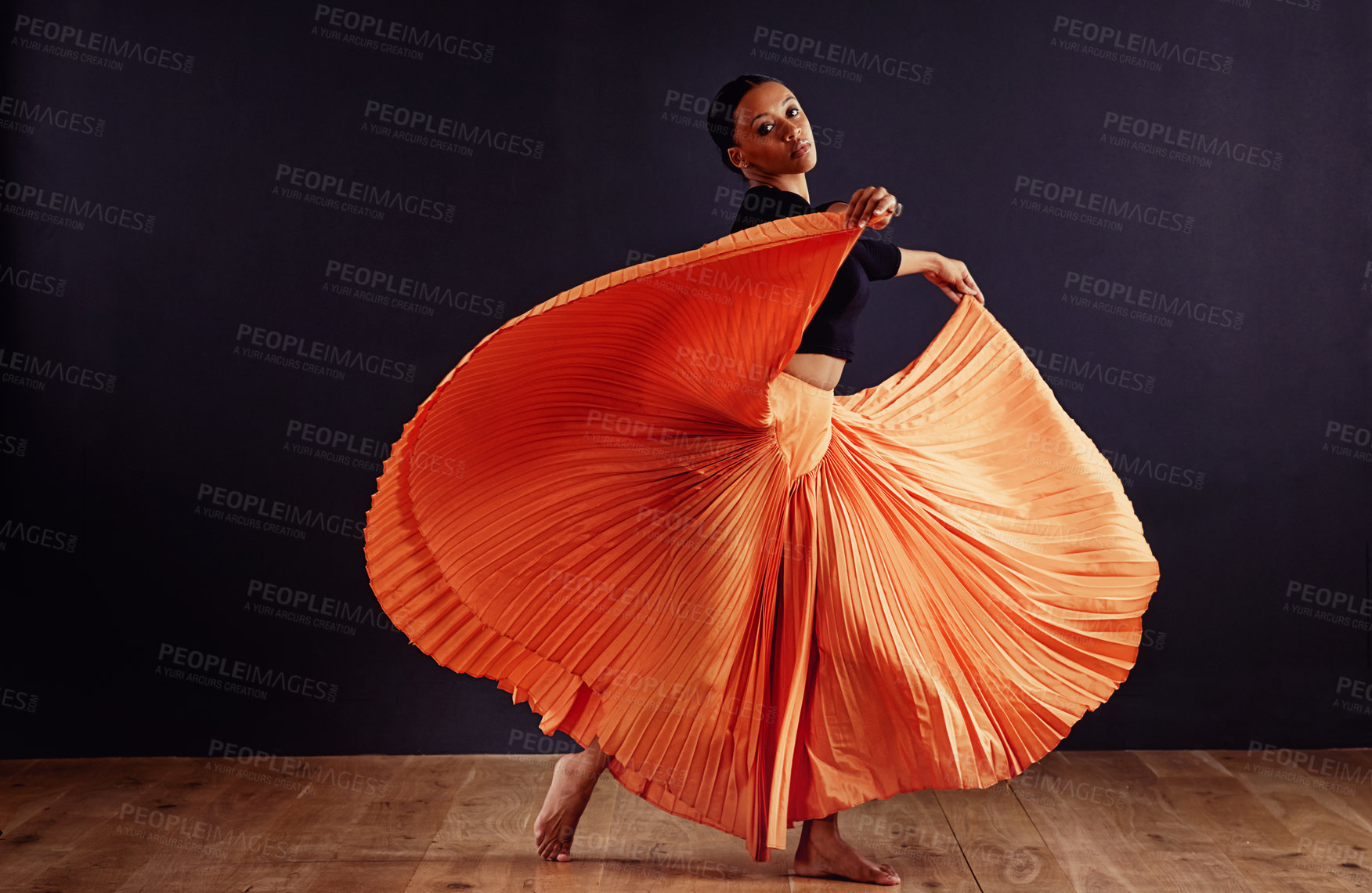 Buy stock photo Female contemporary dancer in a dramatic pose against dark background