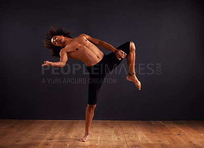 Buy stock photo Male contemporary dancer performing a dramatic pose in front of a dark background