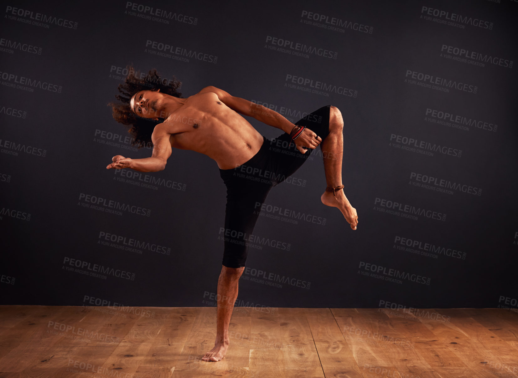 Buy stock photo Male contemporary dancer performing a dramatic pose in front of a dark background