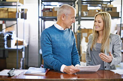 Buy stock photo Discussion, warehouse team and happy business people shipping for storage with senior manager reading document. Factory, paperwork and logistics for inventory, stock and planning together at table