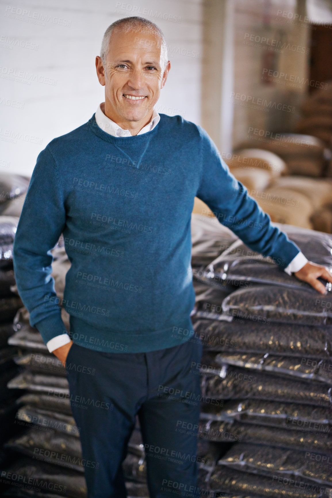 Buy stock photo Coffee beans, storage and portrait of man with bags for distribution, quality control and confident in warehouse. Export, manufacturing and entrepreneur at factory for sustainable logistics business