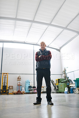 Buy stock photo Man, logistics and portrait with arms crossed in factory for confidence, pride and industry. Senior manager, merchandise and in warehouse for inspection, shipping and distribution in low angle