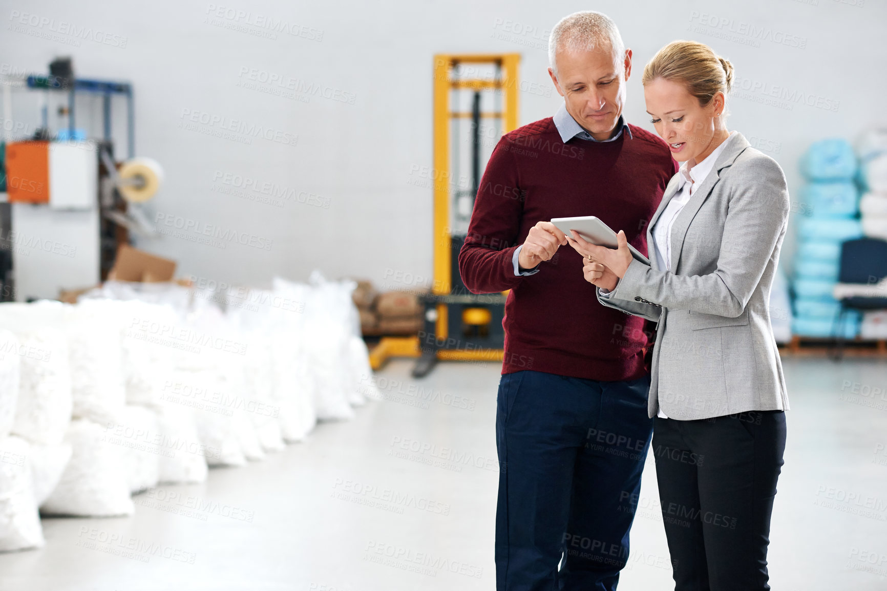 Buy stock photo Logistics, warehouse and business people with tablet for teamwork, supply chain and ecommerce. Mature man, woman and discussion with digital technology for planning, communication or conversation