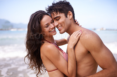Buy stock photo Love, embrace and happy couple at beach for tropical holiday adventure, relax and bonding together. Nature, man and woman smile on romantic date with ocean, blue sky and hug on island vacation.