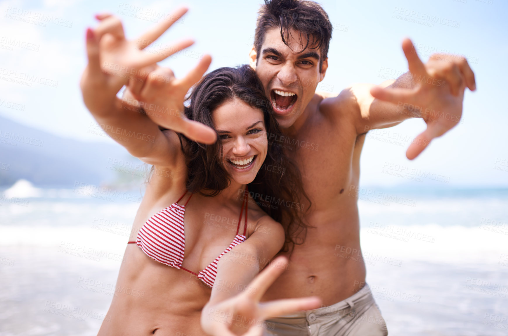 Buy stock photo Love, peace sign and portrait of couple at ocean for tropical holiday adventure, relax or bonding together. Nature, happy man and woman on romantic date with beach, blue sky and smile on fun vacation