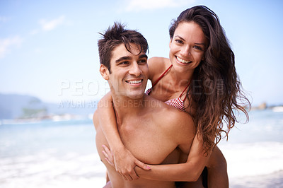 Buy stock photo Smile, piggyback and portrait of couple by beach on vacation, adventure or holiday for romantic travel. Happy, love and young man and woman on date by ocean for tropical anniversary weekend trip.