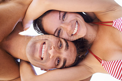 Buy stock photo Low angle, portrait and couple hug with smile, bonding at beach for travel and love in relationship for commitment. Man, woman and happiness together, partner and marriage with trust and support